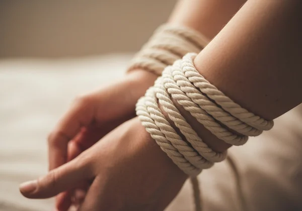 Artistic image of consensual bondage and sensation play.