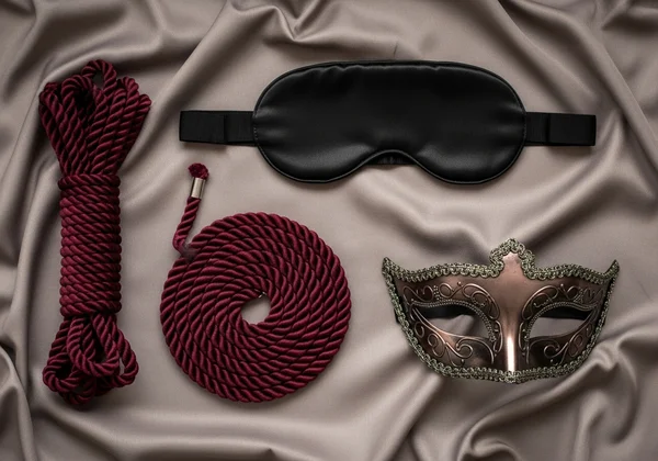 Tasteful flatlay of blindfold and rope for roleplay